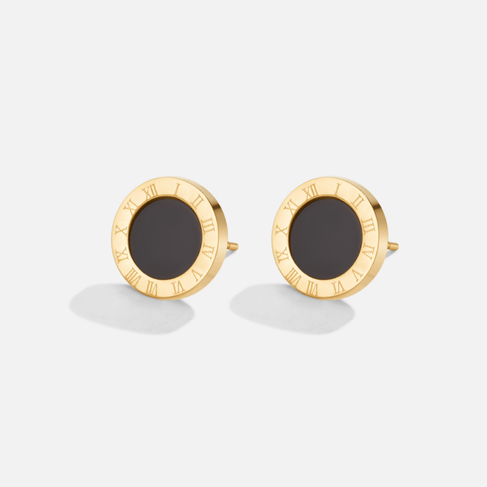 Boucles d’oreilles rondes avec centre noir.