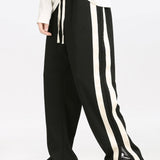 Ensemble — sweat polo patchwork color block & pantalon rayé à ourlet fendu